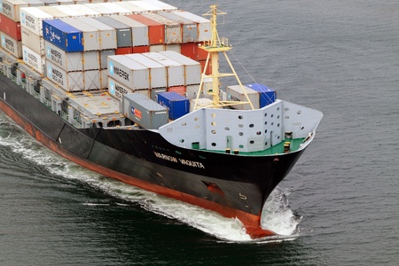 VARNA, BULGARIA - DECEMBER 14: Cargo ship WARNOW VAQUITA (Year Built: 2008) sails into open sea on December 14, 2010 in Varna, Bulgaria. Ship`s next destination is Constanta, Romania.のeditorial素材