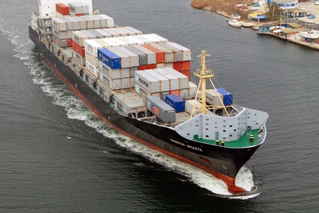 VARNA, BULGARIA - DECEMBER 14: Cargo ship WARNOW VAQUITA (Year Built: 2008) sails into open sea on December 14, 2010 in Varna, Bulgaria. Ship`s next destination is Constanta, Romania.のeditorial素材