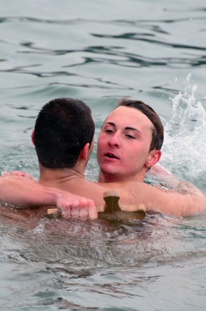 VARNA, BULGARIA - JANUARY 6: Anzhel Dimitrov recovered the cross for a forth successive year. Bulgarian Eastern Orthodox Church honors Epiphany on January 6, 2011 in Varna, Bulgaria のeditorial素材