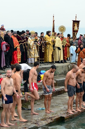 VARNA, BULGARIA - JANUARY 6: A number of young men braved the freezing Black sea waters to safe the cross. Bulgarian Eastern Orthodox Church honors Epiphany on January 6, 2011 in Varna, Bulgaria のeditorial素材