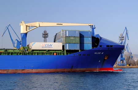 VARNA, BULGARIA, MARCH 14: Turkish cargo ship HILDE A (Year Built: 2005, Dead Weight: 22033 t) is sailing away into open sea after a short stay in Varna-west port on March 14, 2014 in Varna, Bulgariaのeditorial素材