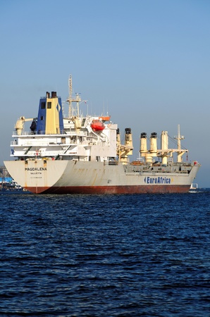 VARNA, BULGARIA - MARCH 14: Cargo ship MAGDALENA (Year Built: 1988, Dead Weight: 13864 t) is sailing away into open sea after a short stay in Varna-west port on March 14, 2011 in Varna, Bulgariaのeditorial素材