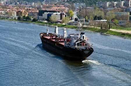 VARNA, BULGARIA - APR 22: Cargo ship LINDEN (Year Built: 1977, Flag: Moldova) sails away into open sea after a short stay in Varna-west port on April 22, 2011 in Varna, Bulgaria.のeditorial素材