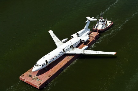 VARNA, BULGARIA - MAY 23, 2011: Airplane is tolled on a platform on May 23, 2011 in Varna, Bulgaria. The old Tu-154 government plane, which belonged to Bulgariaâs communist leader Todor Zhivkov, will be submerged close to the coastal city of Varna and wのeditorial素材