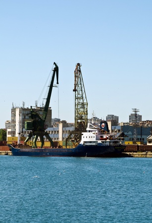 VARNA, BULGARIA - JUNE 07: Cargo ship SEHER YILDIZI (Year Built: 1984, Flag: St Vincent Grenadines) is loaded with 3000 tones of corn in Port of Varna-East on June 07, 2011 in Varna, Bulgaria.のeditorial素材