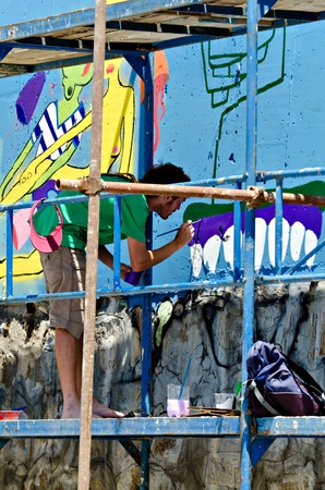 VARNA, BULGARIA - JUNE 2: Graffiti artist on a scaffolding at the "Creatures from Black Sea" Sprite Graffiti Jam 2011 in Port of Varna, on June 2, 2011 in Varna, Bulgaria. のeditorial素材