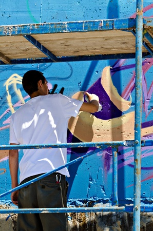 VARNA, BULGARIA - JUNE 2: Graffiti artist on a scaffolding at the "Creatures from Black Sea" Sprite Graffiti Jam 2011 in Port of Varna, on June 2, 2011 in Varna, Bulgaria. のeditorial素材