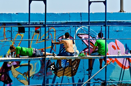 VARNA, BULGARIA - JUNE 2: Graffiti artists on a scaffolding at the "Creatures from Black Sea" Sprite Graffiti Jam 2011 in Port of Varna, on June 2, 2011 in Varna, Bulgaria. のeditorial素材