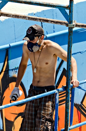 VARNA, BULGARIA - JUNE 2: Graffiti artist on a scaffolding at the "Creatures from Black Sea" Sprite Graffiti Jam 2011 in Port of Varna, on June 2, 2011 in Varna, Bulgaria. のeditorial素材