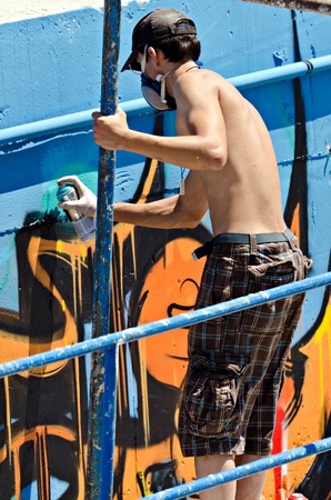 VARNA, BULGARIA - JUNE 2: Graffiti artist on a scaffolding at the "Creatures from Black Sea" Sprite Graffiti Jam 2011 in Port of Varna, on June 2, 2011 in Varna, Bulgaria. のeditorial素材