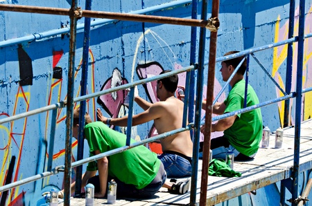 VARNA, BULGARIA - JUNE 2: Graffiti artists on a scaffolding at the "Creatures from Black Sea" Sprite Graffiti Jam 2011 in Port of Varna, on June 2, 2011 in Varna, Bulgaria. のeditorial素材