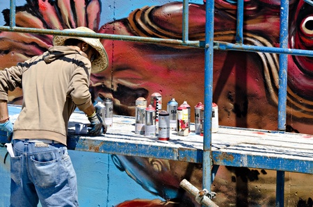 VARNA, BULGARIA - JUNE 2: Graffiti artist on a scaffolding at the "Creatures from Black Sea" Sprite Graffiti Jam 2011 in Port of Varna, on June 2, 2011 in Varna, Bulgaria. のeditorial素材