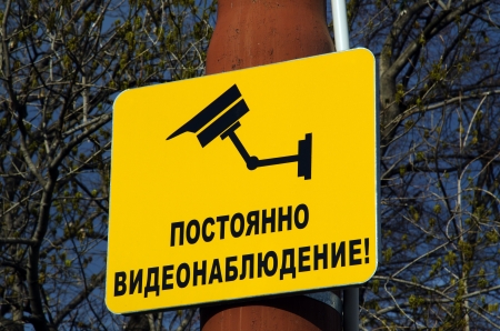 Yellow CCTV sign mounted on a post  Inscription  Constant video surveillance   Bulgarian の写真素材