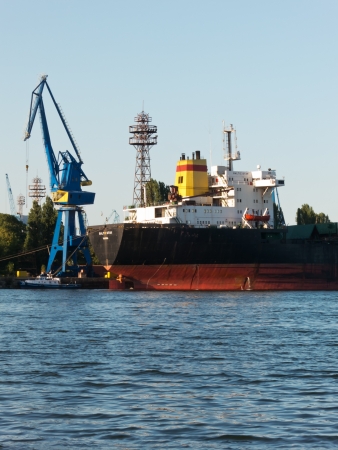 VARNA, BULGARIA - JULY 21: Bulk carrier BALTIC STAR, Flag: Bulgaria, Year Built: 1985, is loaded with goods on July 21, 2012 in Varna, Bulgaria.のeditorial素材