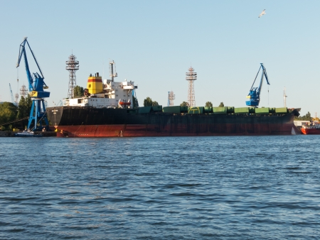 VARNA, BULGARIA - JULY 21: Bulk carrier BALTIC STAR, Flag: Bulgaria, Year Built: 1985, is loaded with goods on July 21, 2012 in Varna, Bulgaria.のeditorial素材