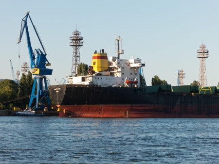 VARNA, BULGARIA - JULY 21: Bulk carrier BALTIC STAR, Flag: Bulgaria, Year Built: 1985, is loaded with goods on July 21, 2012 in Varna, Bulgaria.のeditorial素材