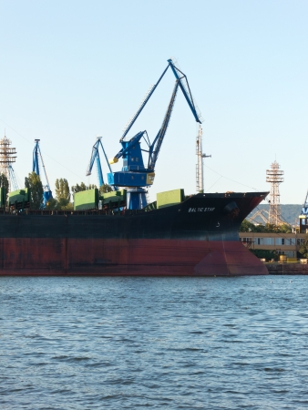 VARNA, BULGARIA - JULY 21: Bulk carrier BALTIC STAR, Flag: Bulgaria, Year Built: 1985, is loaded with goods on July 21, 2012 in Varna, Bulgaria.のeditorial素材