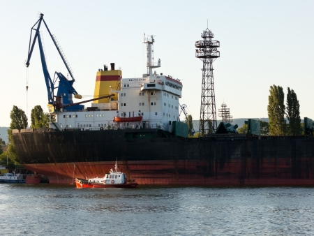 VARNA, BULGARIA - JULY 21: Bulk carrier BALTIC STAR, Flag: Bulgaria, Year Built: 1985, is loaded with goods on July 21, 2012 in Varna, Bulgaria.のeditorial素材