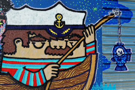 Varna, BULGARIA - December 14, 2014: Street art by unknown artist of a captain holding a fishing rod close to Port of Varna.のeditorial素材