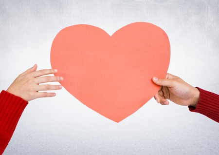 Close-up of hands holding a red heartの写真素材