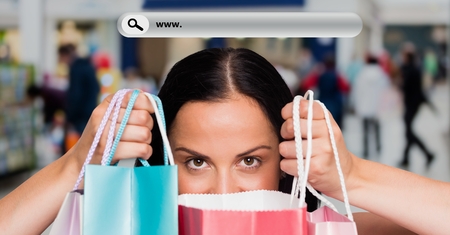 Digital composite image of beautiful woman holding shopping bags with search barの写真素材