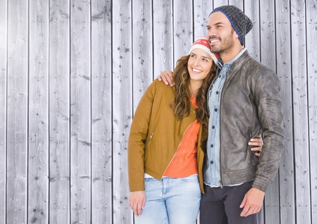 Romantic couple standing against wooden backgroundの写真素材