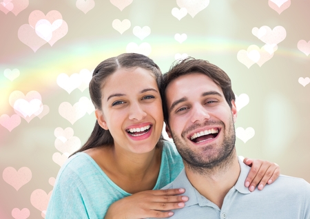 Composite image of laughing couple against hearts in backgroundの写真素材