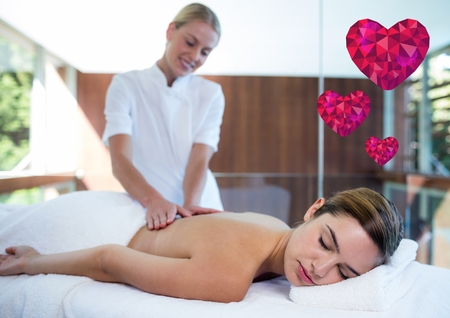Woman receiving spa with digitally generated heartの写真素材