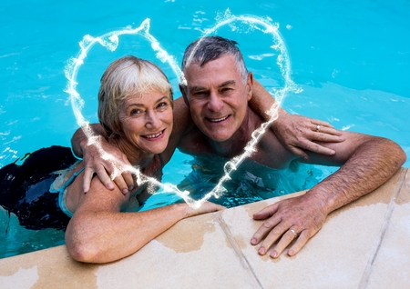 Composite image of couple with arm around in swimming poolの写真素材