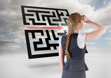 Digital composite image businesswoman shielding her eyes while looking at skyの写真素材