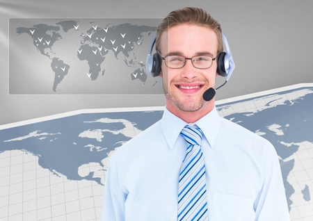 Portrait of smiling businessman with headset in office against digitally generated backgroundの写真素材