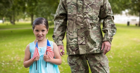 Portrait of girl holding american flag in parkの写真素材