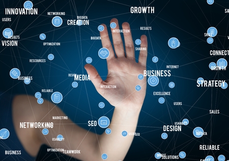 Mid section of woman touching digitally generated business iconsの写真素材