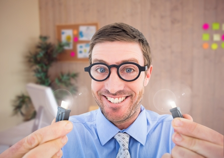 Portrait of nerd man holding cables with flare in officeの写真素材