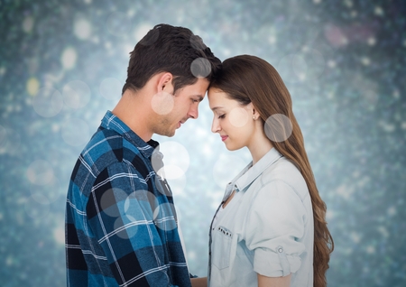 Composite image of romantic couple embracing each other against bokeh backgroundの写真素材
