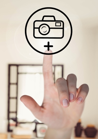 Close-up of hand touching digitally generated photo camera iconの写真素材