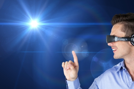 Woman using virtual reality headset against digitally generated backgroundの写真素材