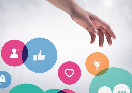 Composite of hand with application icons against white backgroundの写真素材