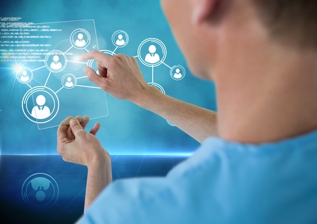 Doctor touching digitally generated icon against blue background