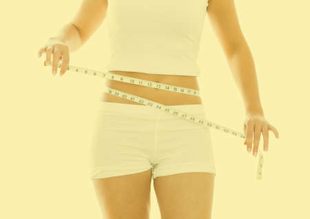 Woman measuring her waistの写真素材
