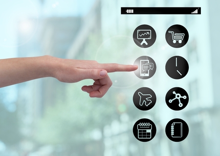 Close up of hand touching digitally generated application icons interfaceの写真素材