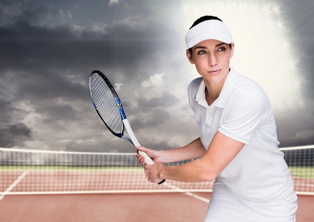 Digital composite of Tennis player on court with bright light and dark cloudsの写真素材