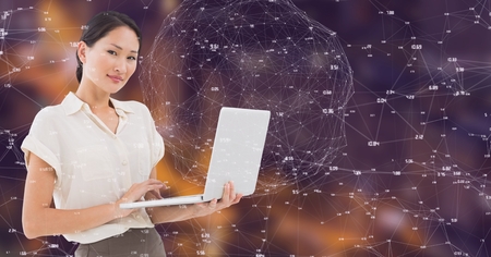 Digital composite of Businesswoman with laptop Night city with connectorsの写真素材