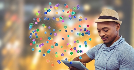 Digital composite of Man touching tablet against Night city with connectors