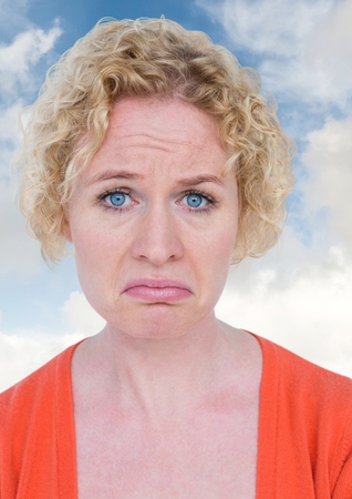 Digital composite of Sad woman crying against blue skyの写真素材