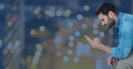 Digital composite of Man with phone against Night cityの写真素材