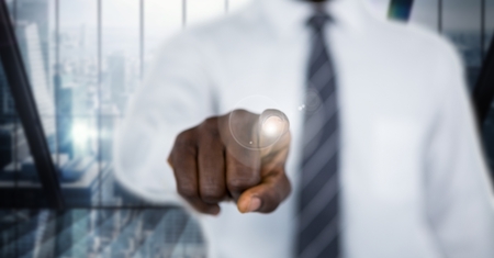 Digital composite of Business man mid section with flare against blurry windowの写真素材