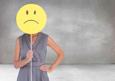 Digital composite of Sad woman holding face against grey backgroundの写真素材