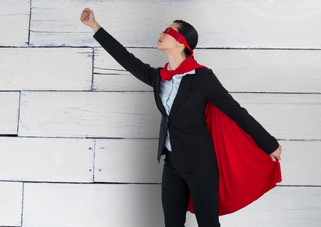 Digital composite of Business Superhero against woodの写真素材