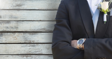 Digital composite of Wedding groom torso against woodの写真素材